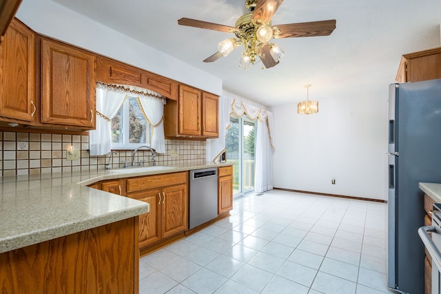6934 Colonial Dr, Tecumseh, MI 49286 - kitchen featuring dishwasher, a sink, decorative backsplash, freestanding refrigerator, and brown cabinets