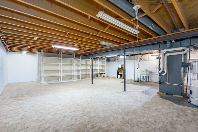 6934 Colonial Dr, Tecumseh, MI 49286 - basement featuring heating unit, water heater, carpet, and a sink