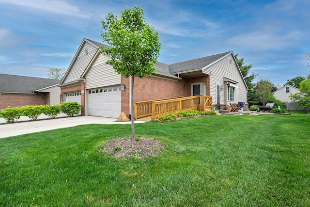 view of front of house with an attached garage, brick siding, a front yard, driveway, and a deck