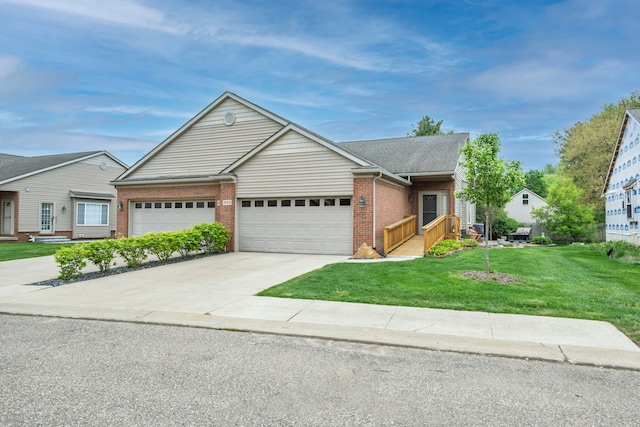 view of front of home with brick siding, a front lawn, an attached garage, and concrete driveway