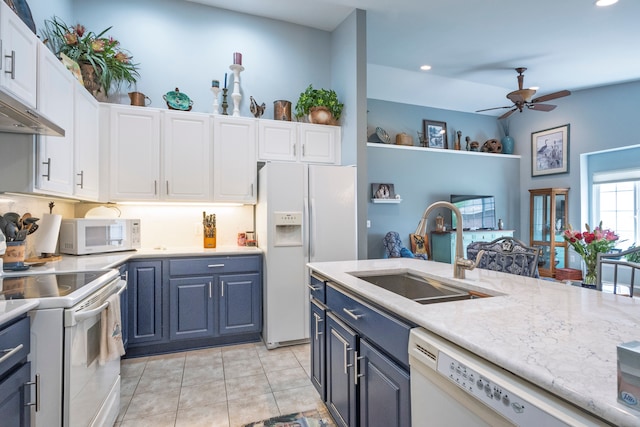 kitchen featuring white appliances, a sink, ceiling fan, blue cabinets, and white cabinets