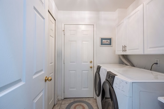 laundry room with cabinet space, light tile patterned floors, and independent washer and dryer