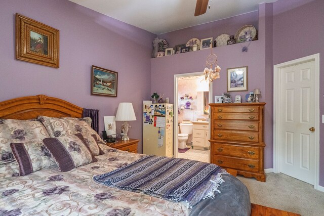 bedroom with connected bathroom, a chandelier, and a ceiling fan