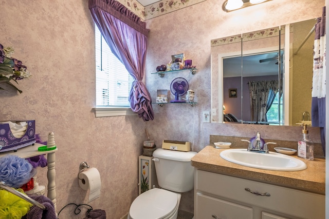 half bathroom with toilet and vanity