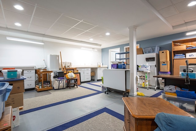 basement with a paneled ceiling and recessed lighting