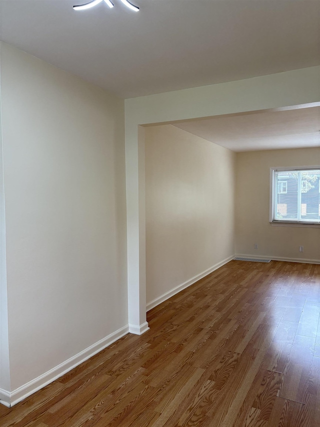 unfurnished room featuring wood finished floors and baseboards