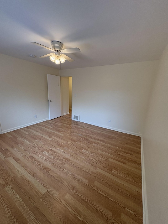 unfurnished room featuring a ceiling fan, light wood-style floors, and baseboards