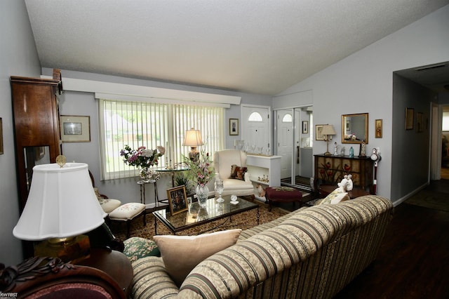 living area with vaulted ceiling, wood finished floors, and baseboards