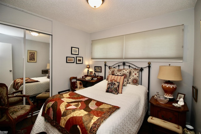 bedroom with a closet and a textured ceiling