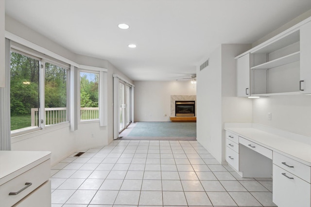 3239 Bellflower Ct, Ann Arbor, MI 48103 - kitchen featuring open shelves, ceiling fan, light countertops, white cabinets, and a high end fireplace