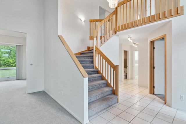 3239 Bellflower Ct, Ann Arbor, MI 48103 - stairway with a high ceiling, baseboards, and tile patterned flooring