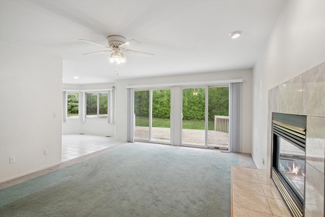 3239 Bellflower Ct, Ann Arbor, MI 48103 - unfurnished living room featuring a tiled fireplace, light carpet, a ceiling fan, and recessed lighting
