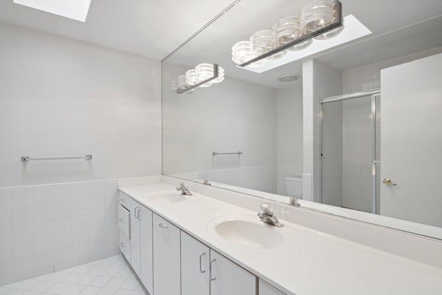 3239 Bellflower Ct, Ann Arbor, MI 48103 - full bath with toilet, a stall shower, tile walls, double vanity, and a skylight