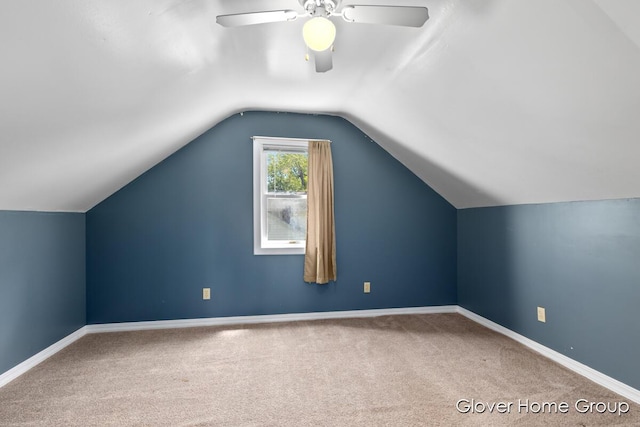additional living space with carpet, a ceiling fan, vaulted ceiling, and baseboards