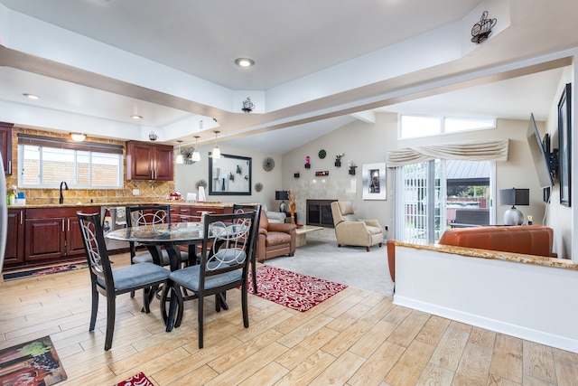 12848 E 14 Mile Rd, Warren, MI 48088 - dining space featuring light wood-style flooring and a fireplace