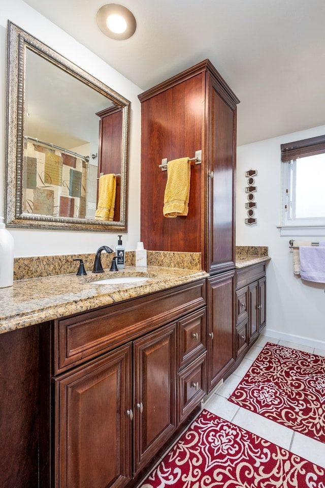 12848 E 14 Mile Rd, Warren, MI 48088 - bathroom with tile patterned flooring, vanity, and baseboards