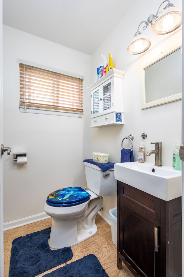 12848 E 14 Mile Rd, Warren, MI 48088 - half bath with toilet, wood finished floors, vanity, and baseboards
