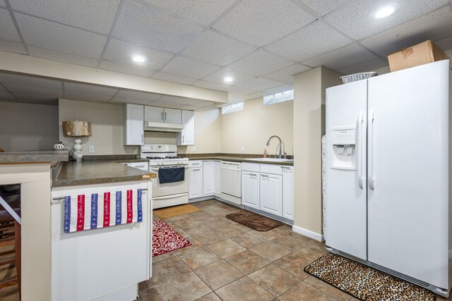12848 E 14 Mile Rd, Warren, MI 48088 - kitchen featuring white appliances, a sink, dark countertops, white cabinetry, and a drop ceiling