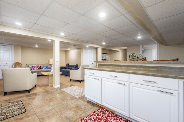 12848 E 14 Mile Rd, Warren, MI 48088 - kitchen with open floor plan, white cabinetry, dark countertops, a drop ceiling, and recessed lighting