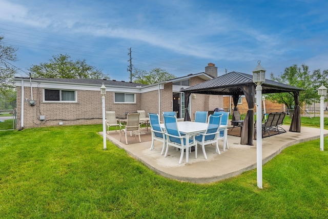 12848 E 14 Mile Rd, Warren, MI 48088 - back of property featuring a gazebo, brick siding, and a patio area