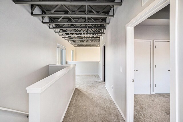 600 Douglas St NW Unit 600C, Grand Rapids, MI 49504 - hallway with carpet flooring, an upstairs landing, and baseboards