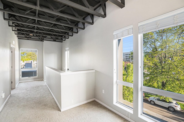 600 Douglas St NW Unit 600C, Grand Rapids, MI 49504 - hallway with carpet, baseboards, and an upstairs landing