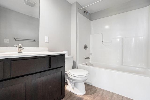 600 Douglas St NW Unit 600C, Grand Rapids, MI 49504 - bathroom featuring wood finished floors, toilet, vanity, and shower / tub combination