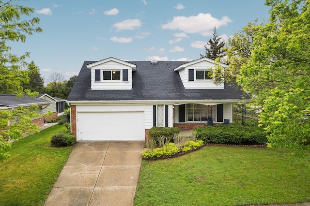 cape cod home featuring brick siding, a front yard, and driveway