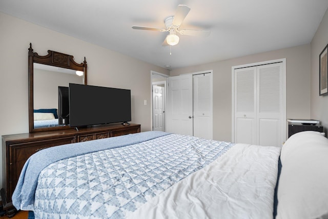 bedroom with multiple closets and ceiling fan