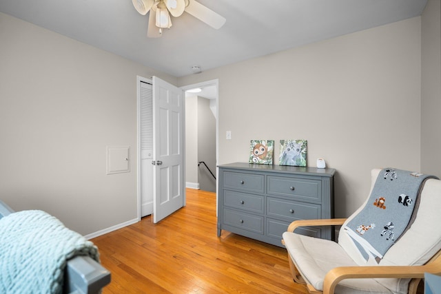 bedroom featuring light wood finished floors, baseboards, and ceiling fan