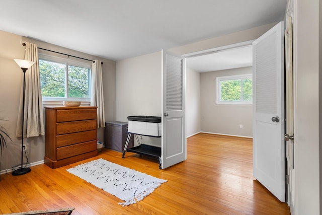 bedroom featuring light wood-type flooring and baseboards