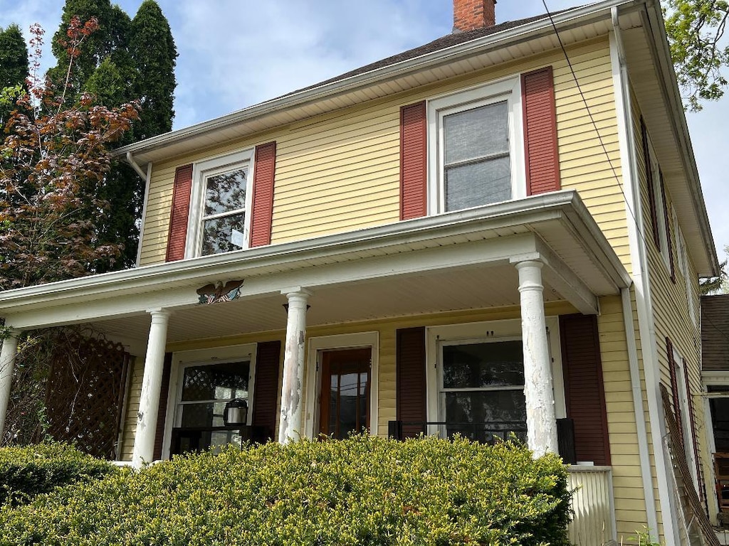 311 N Washington St, Charlotte, MI 48813 - view of front of home with a chimney and a porch
