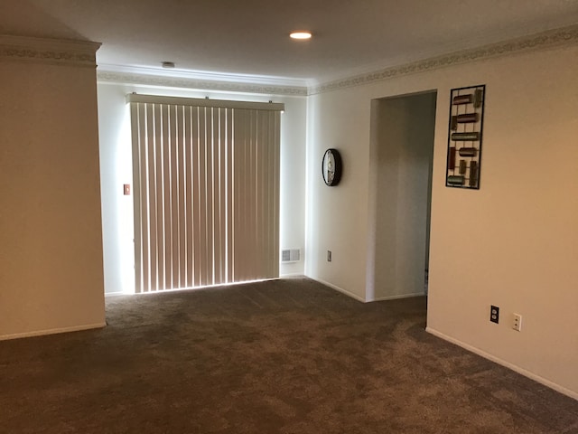 spare room featuring crown molding, carpet floors, and baseboards