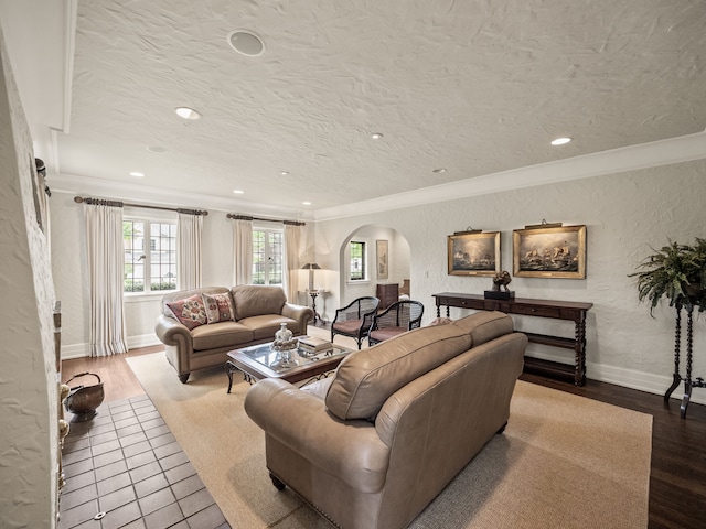 404 Linden Rd, Birmingham, MI 48009 - living room featuring arched walkways, ornamental molding, a textured wall, baseboards, and wood finished floors