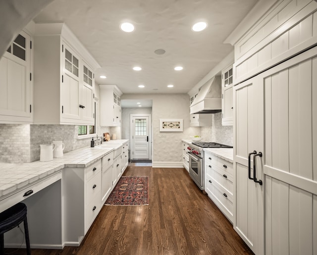 404 Linden Rd, Birmingham, MI 48009 - kitchen featuring high end stove, custom range hood, recessed lighting, white cabinetry, and glass insert cabinets