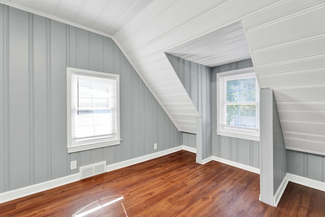 950 W Lincoln St, Birmingham, MI 48009 - additional living space with wood finished floors, baseboards, lofted ceiling, and a decorative wall