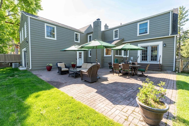 950 W Lincoln St, Birmingham, MI 48009 - rear view of house featuring a patio, an outdoor hangout area, central air condition unit, a chimney, and roof with shingles