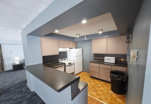 8200 E Jefferson Ave Unit 59/602, Detroit, MI 48214 - kitchen with white appliances, dark countertops, under cabinet range hood, and a peninsula