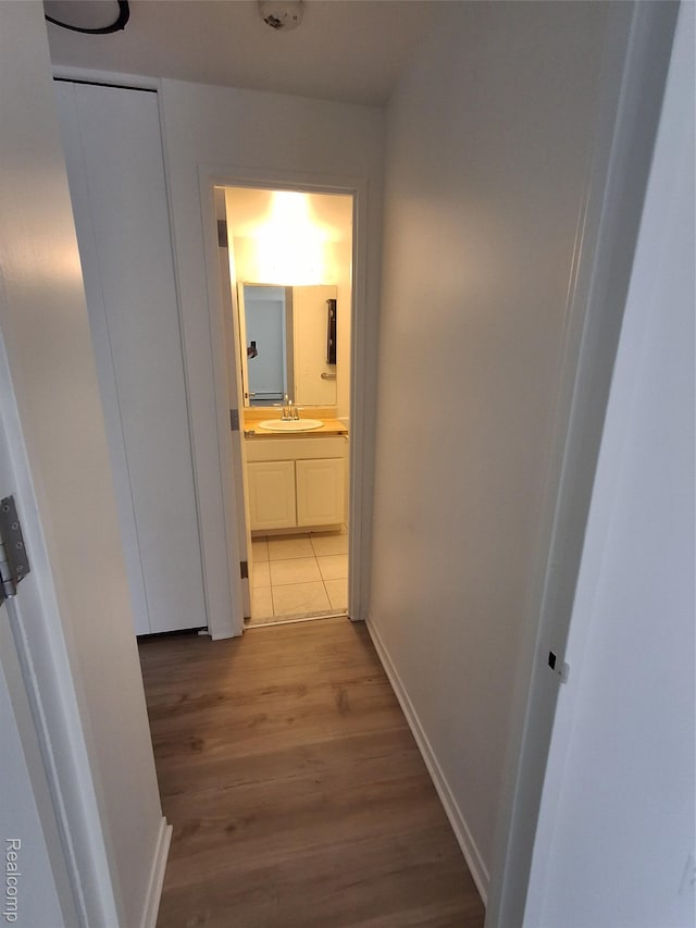 8200 E Jefferson Ave Unit 59/602, Detroit, MI 48214 - hall featuring light wood-style floors, baseboards, and a sink