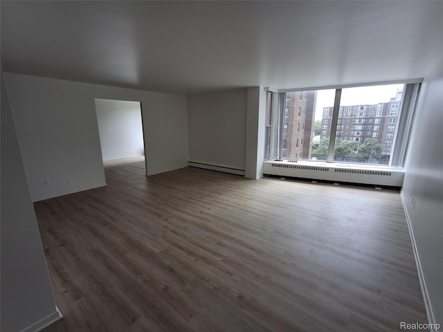 8200 E Jefferson Ave Unit 59/602, Detroit, MI 48214 - unfurnished living room with baseboard heating, wood finished floors, and a baseboard heating unit