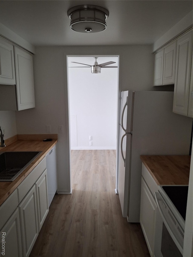8200 E Jefferson Ave Unit 59/602, Detroit, MI 48214 - kitchen featuring white appliances, a sink, light wood-style flooring, white cabinetry, and butcher block countertops