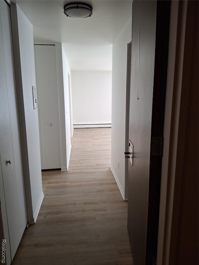 8200 E Jefferson Ave Unit 59/602, Detroit, MI 48214 - hall with baseboards, wood finished floors, and baseboard heating
