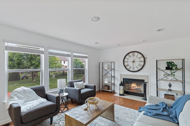 14190 Elmhurst Dr, Sterling Heights, MI 48313 - living room with a fireplace with flush hearth, wood finished floors, and recessed lighting