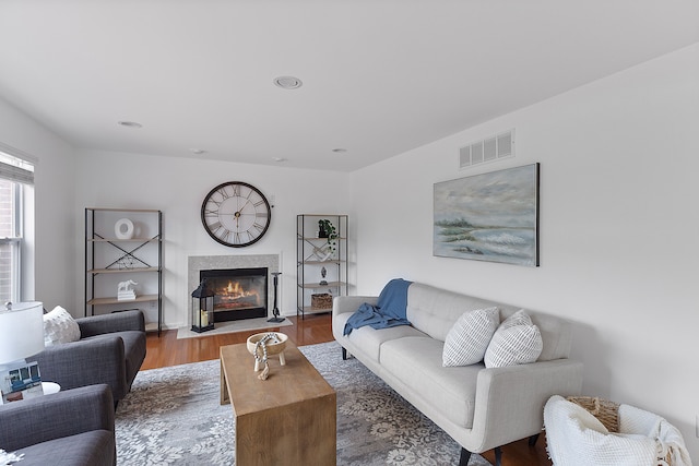 14190 Elmhurst Dr, Sterling Heights, MI 48313 - living room with wood finished floors, a fireplace with flush hearth, and recessed lighting