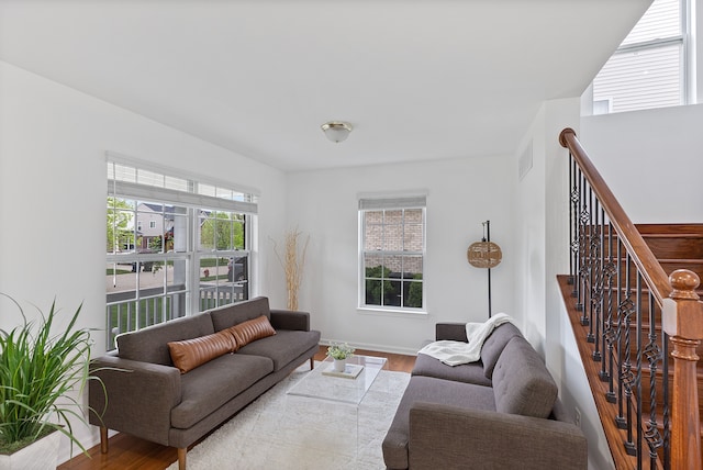 14190 Elmhurst Dr, Sterling Heights, MI 48313 - living area featuring wood finished floors, baseboards, and stairs