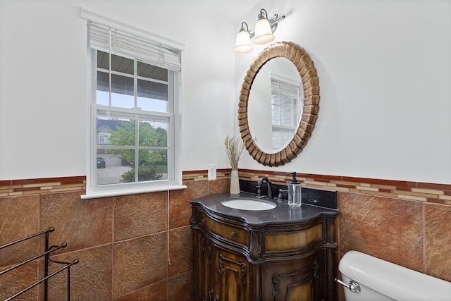 14190 Elmhurst Dr, Sterling Heights, MI 48313 - bathroom featuring tile walls, toilet, wainscoting, and vanity
