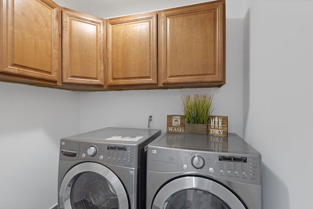 14190 Elmhurst Dr, Sterling Heights, MI 48313 - laundry area featuring washer and dryer and cabinet space