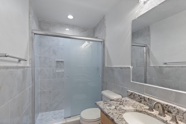 14190 Elmhurst Dr, Sterling Heights, MI 48313 - full bathroom with a stall shower, tile walls, toilet, vanity, and recessed lighting