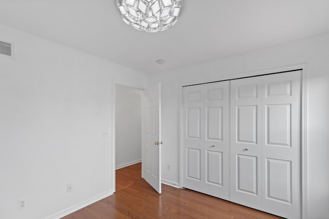 14190 Elmhurst Dr, Sterling Heights, MI 48313 - unfurnished bedroom featuring wood finished floors, a closet, and baseboards