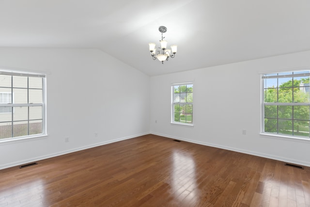 14190 Elmhurst Dr, Sterling Heights, MI 48313 - empty room featuring a chandelier, vaulted ceiling, dark wood finished floors, and baseboards